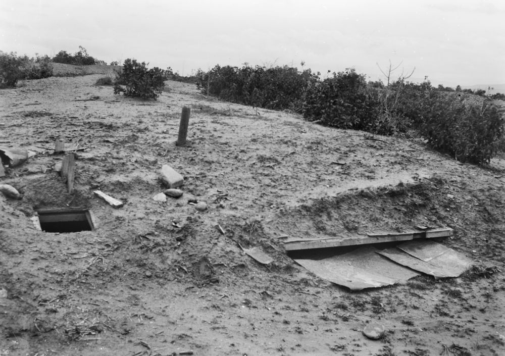 One of several machine gun positions on Baby 700 which covered the Nek. The one shown has been covered, to the left is the access point to the trench.  1919
